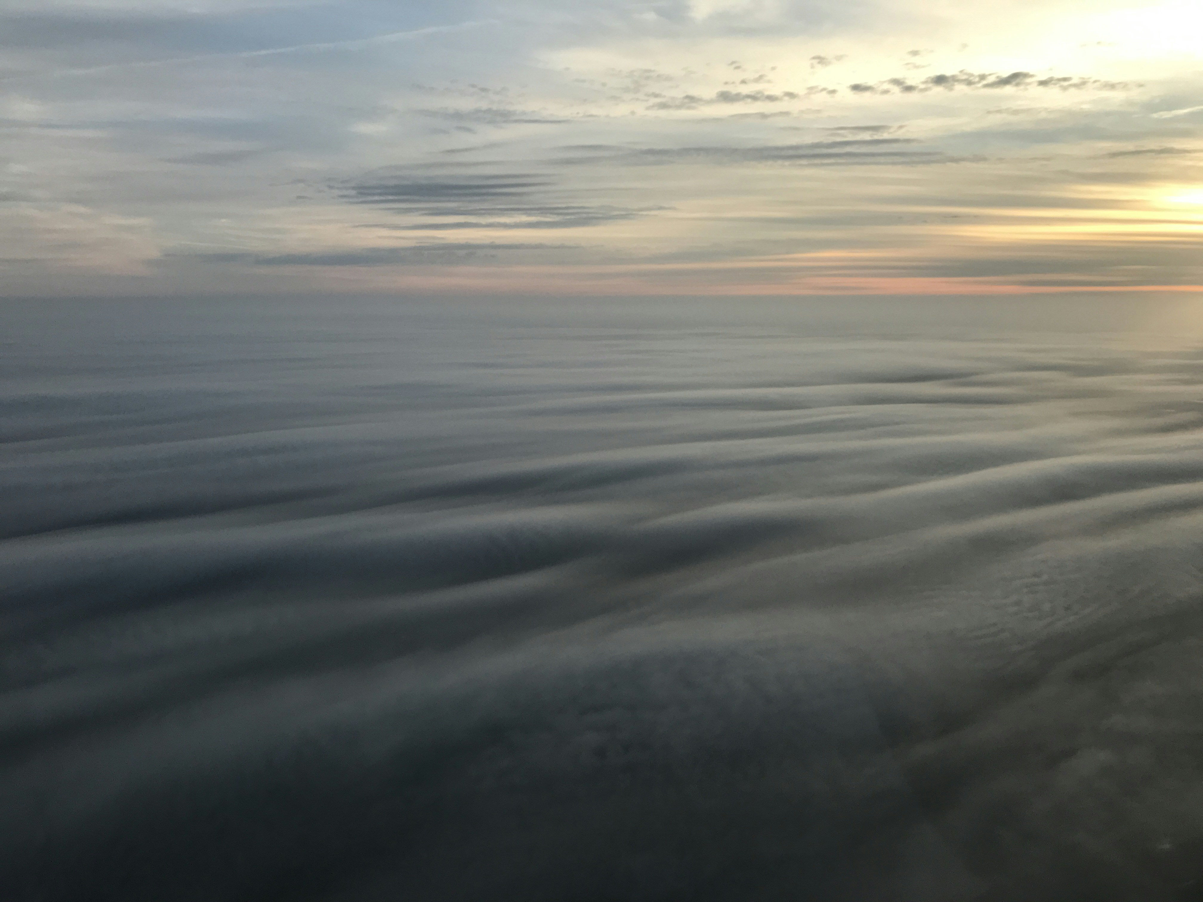 a large body of water under a cloudy sky