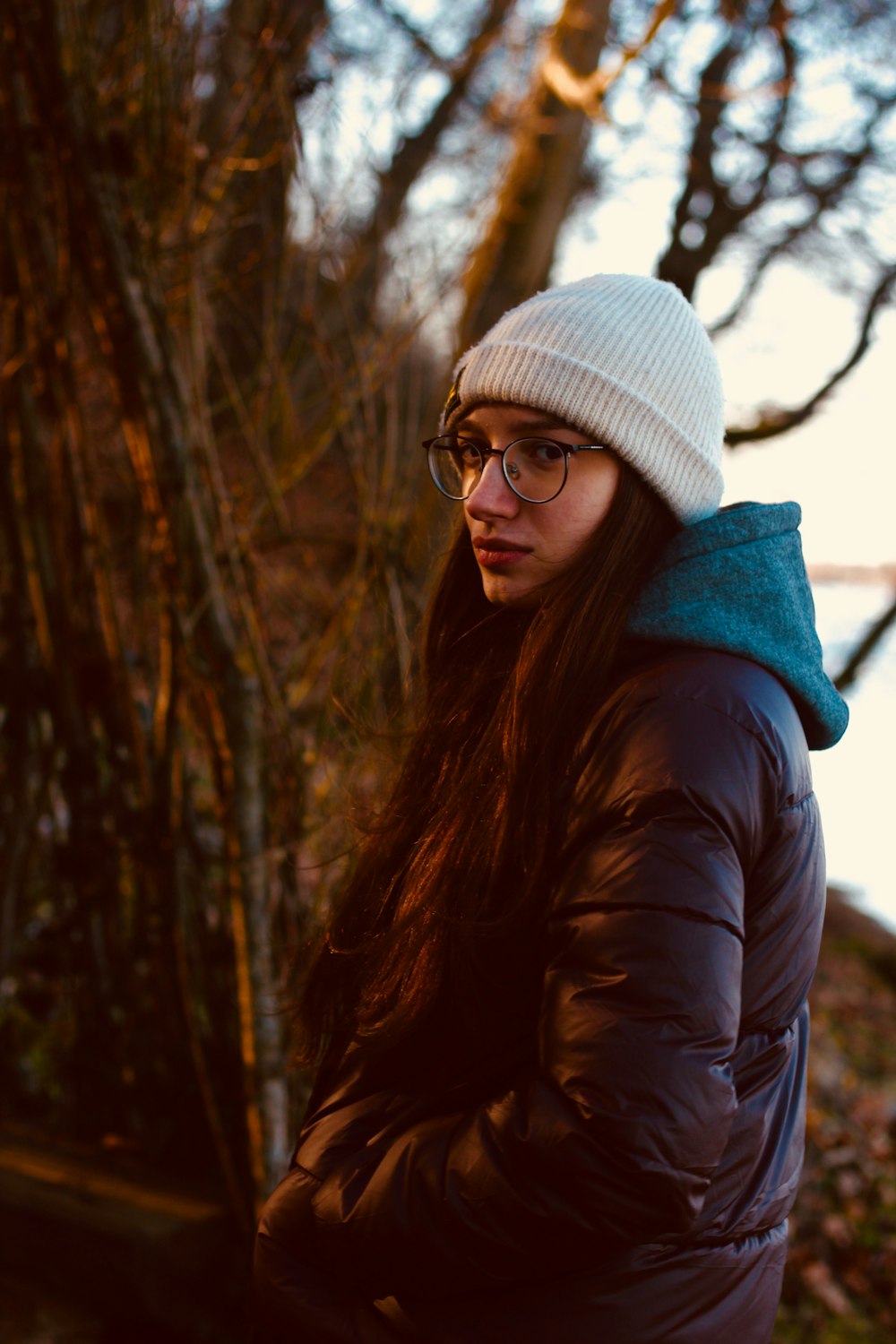 a woman with glasses and a white hat