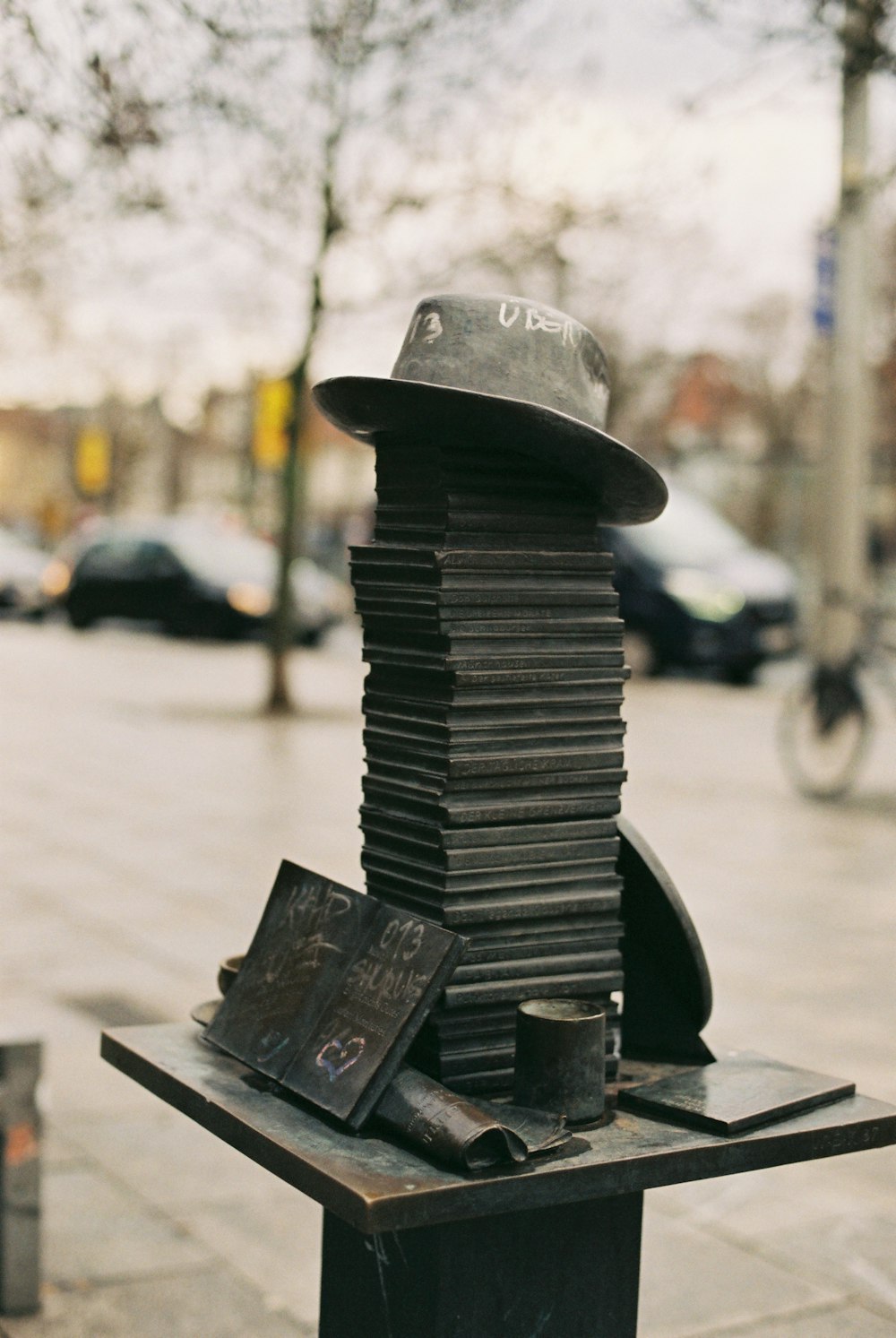 a pile of books sitting on top of a metal stand