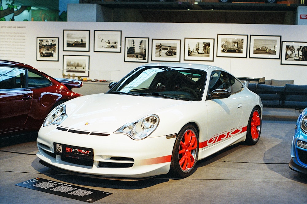 a white sports car parked in a showroom