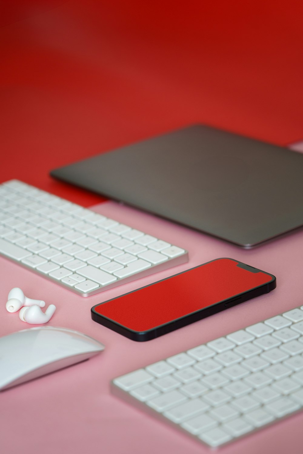 a desk with a keyboard, mouse, and a tablet