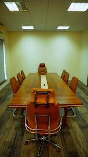 a conference table with a laptop on top of it