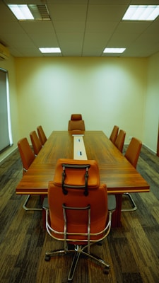 a conference table with a laptop on top of it