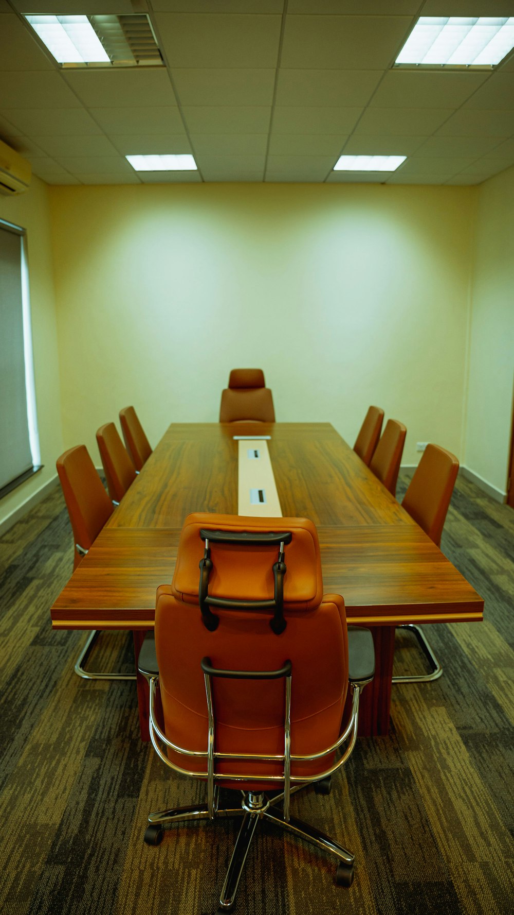 a conference table with a laptop on top of it