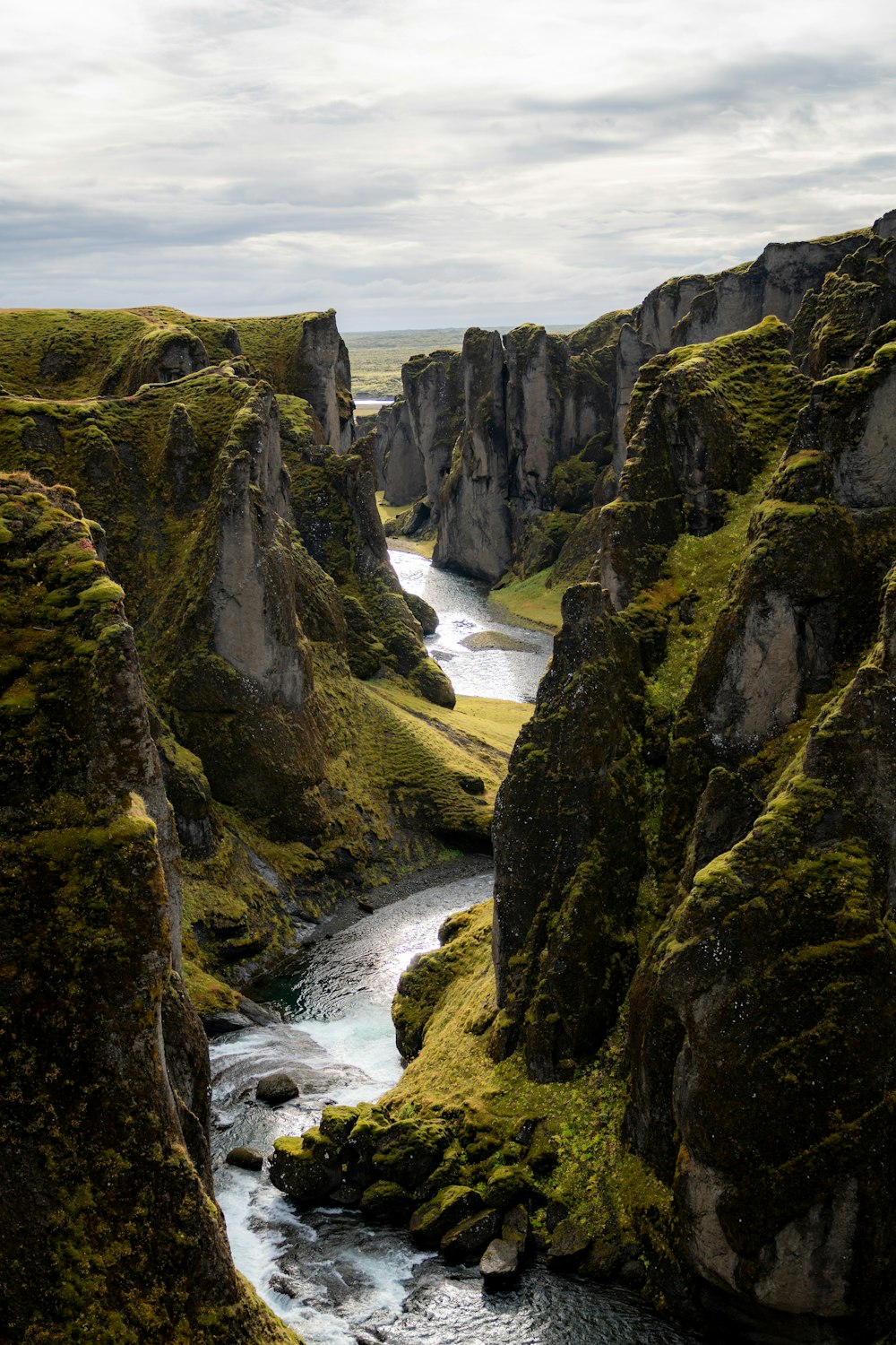 a river flowing through a lush green valley