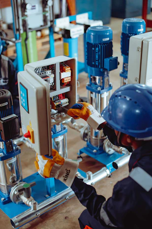 a man working on a machine in a factory