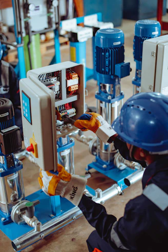 a man working on a machine in a factory