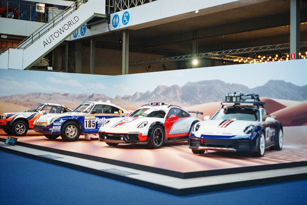 a group of race cars sitting on top of a stage