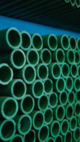a stack of green pipes stacked on top of each other