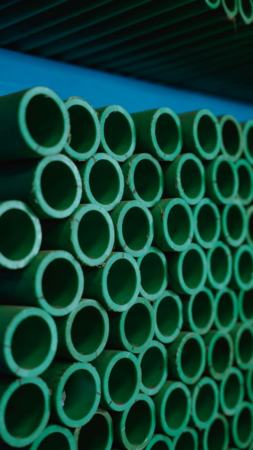 a stack of green pipes stacked on top of each other