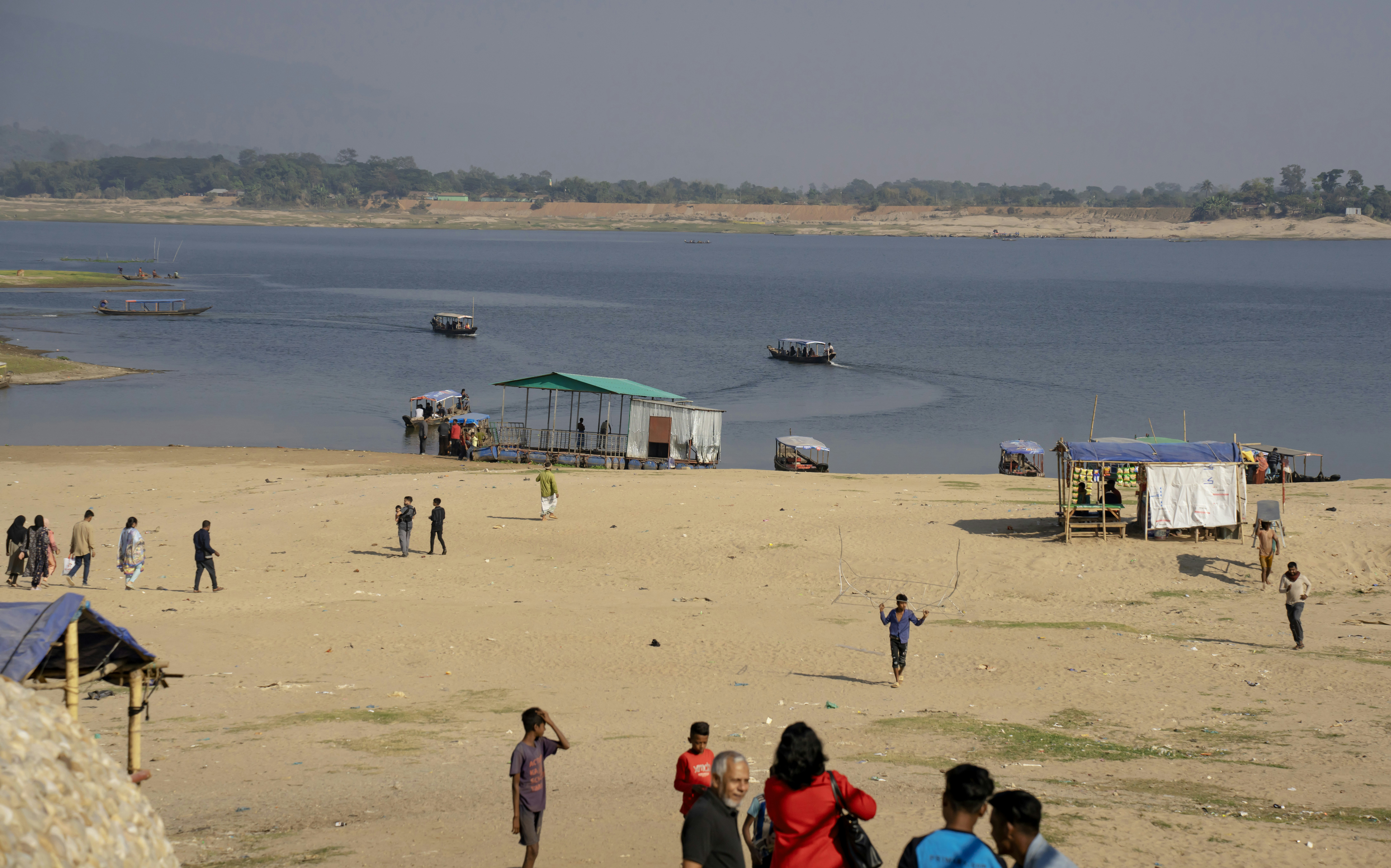 Tourists exploring the sandy stretches and rock formations of a popular natural site