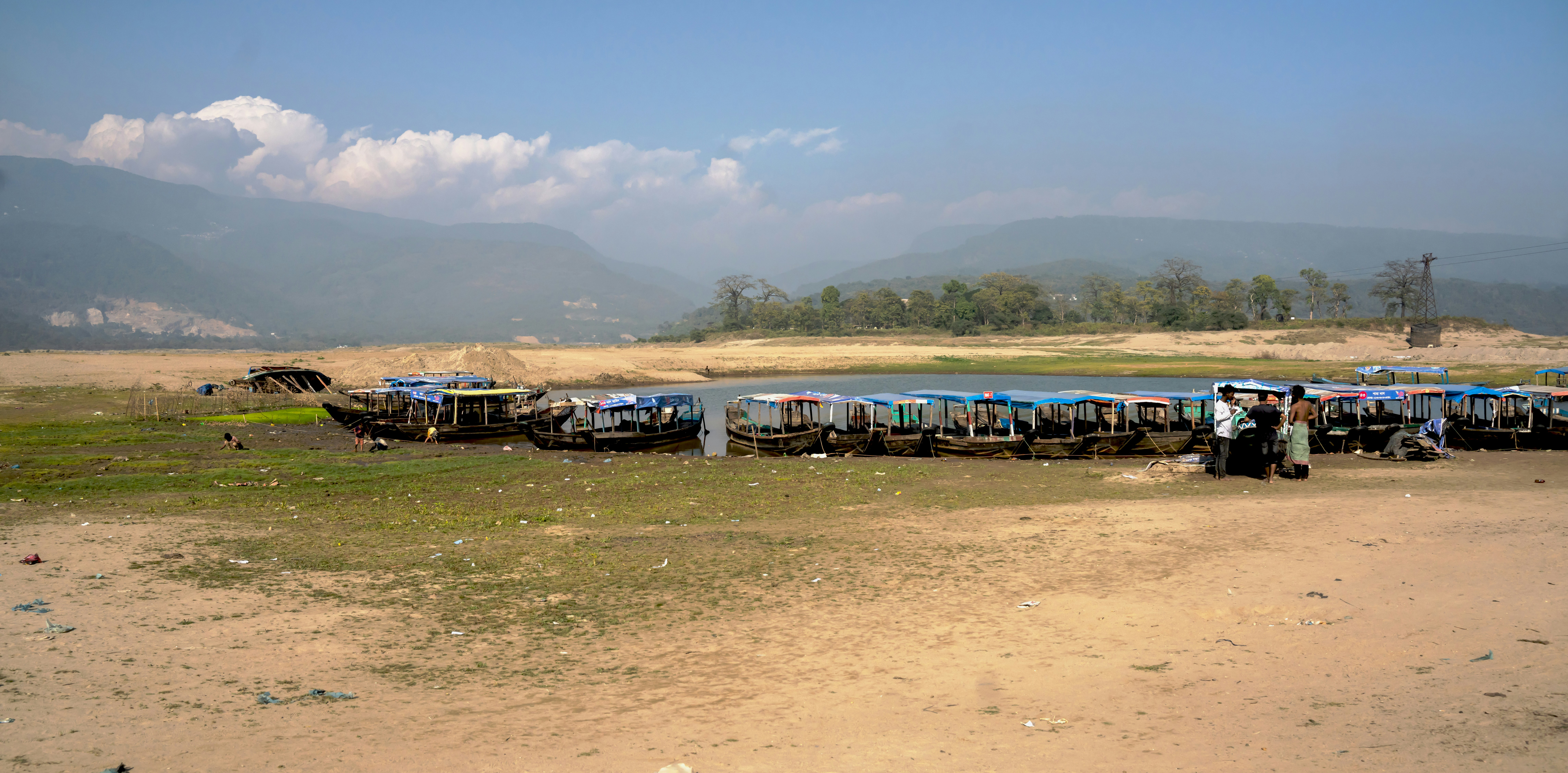 a group of boats sitting on top of a dry grass field