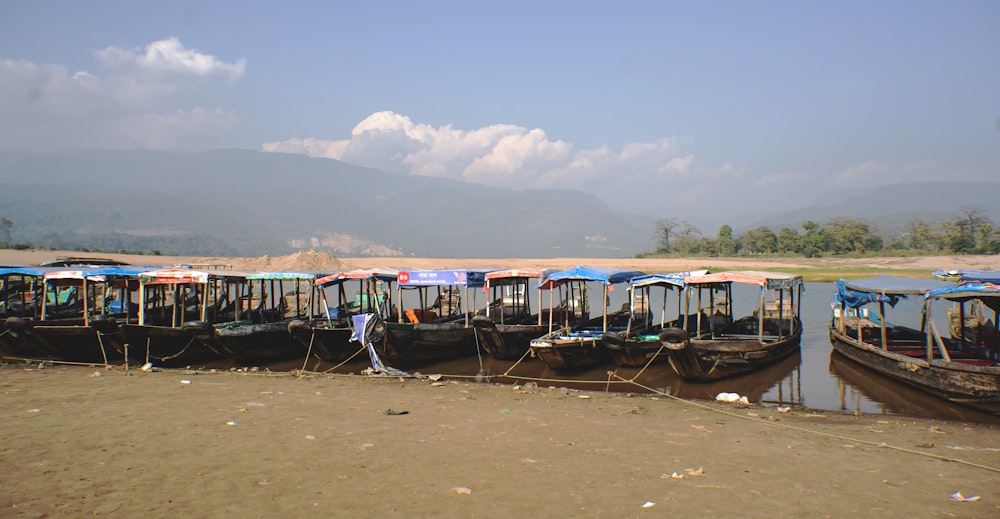 a bunch of boats that are sitting in the sand