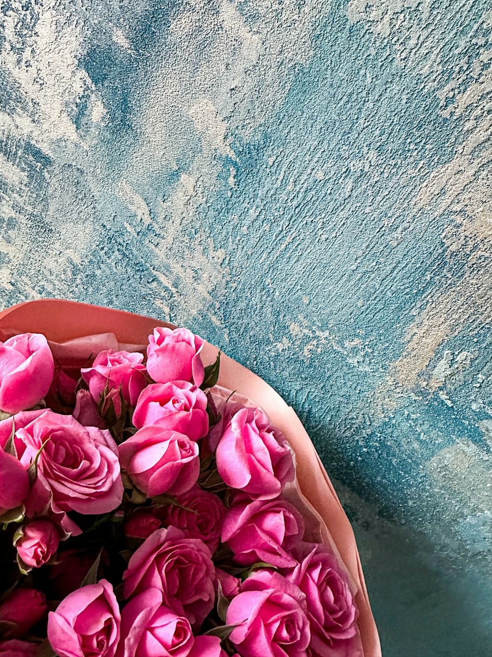 a bunch of pink roses in a pink bowl