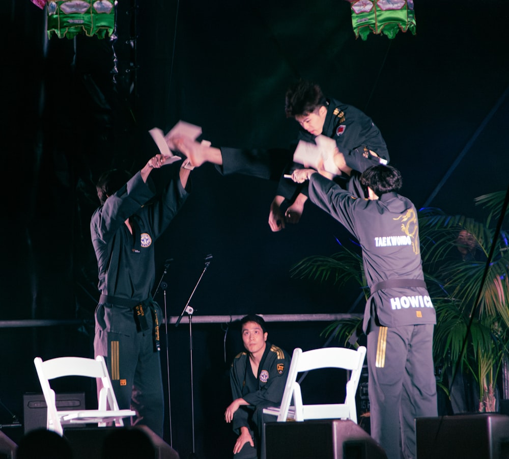 two men performing a kick in front of a crowd