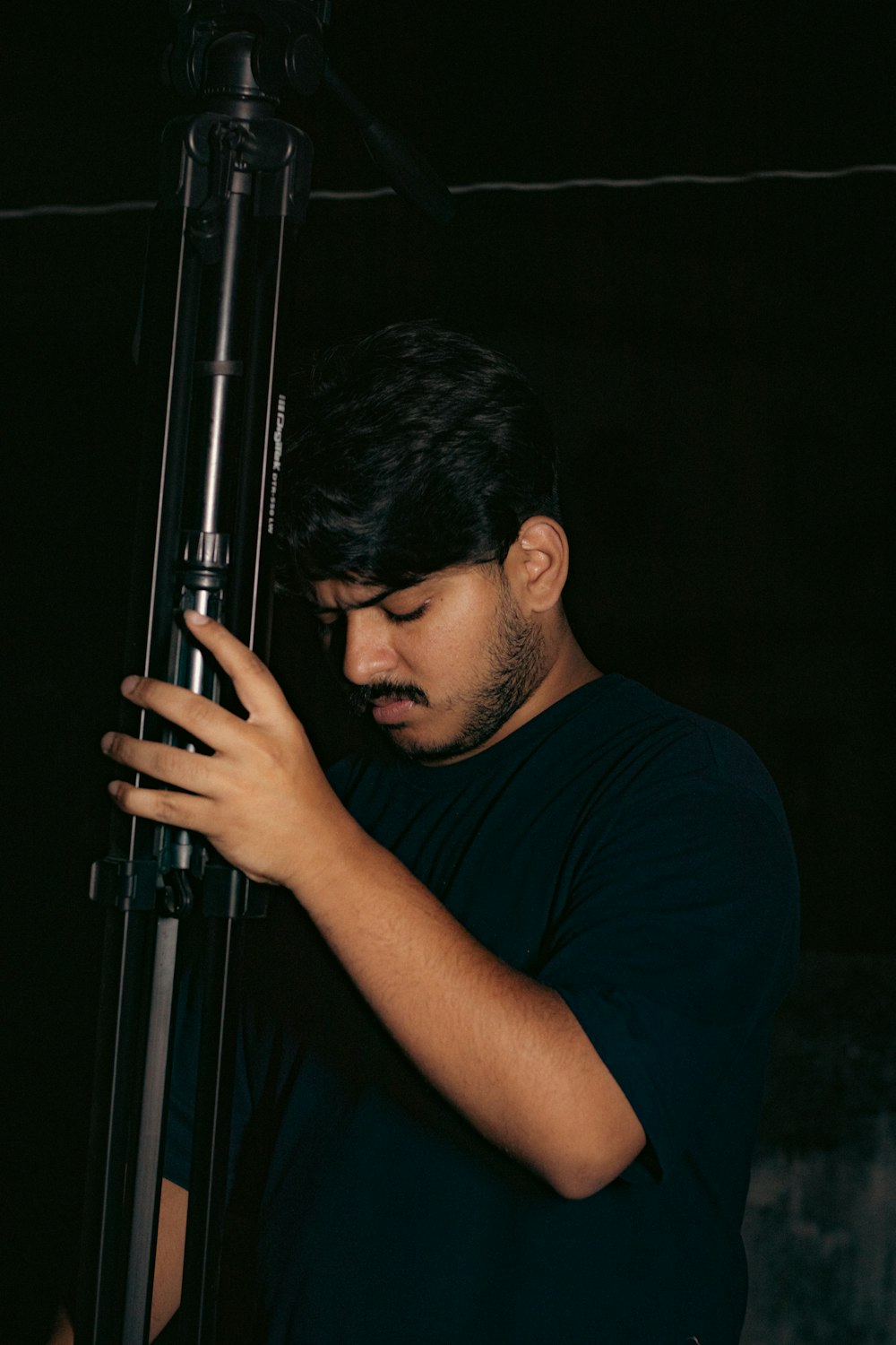 a man holding a large metal object in his hands