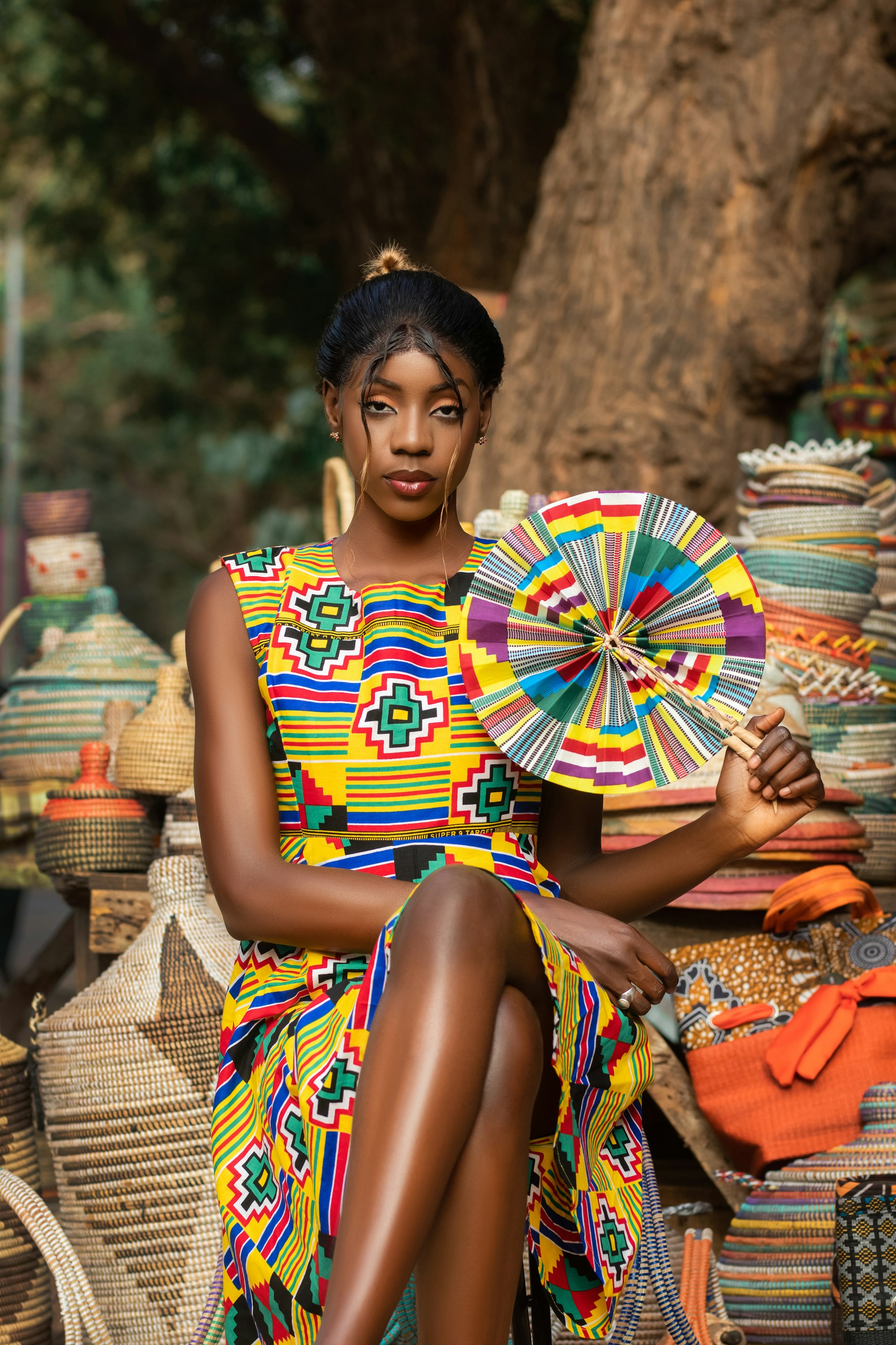 a woman in a colorful dress sitting on a bench
