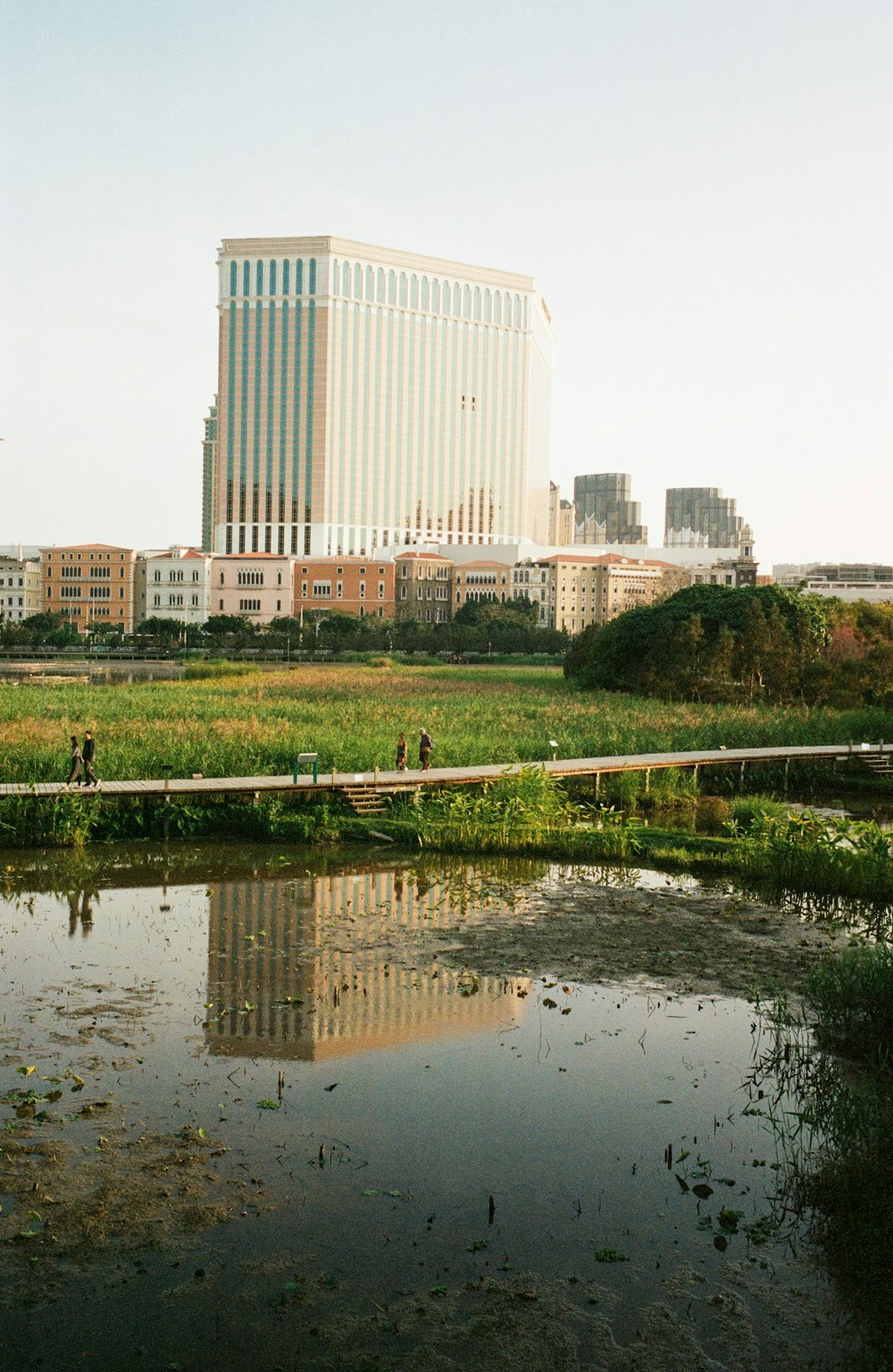 a body of water in front of a tall building