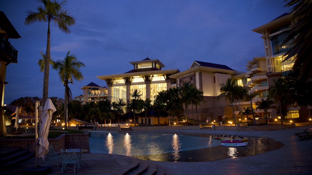 a large building with a pool in front of it