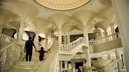 a man and a child are walking up the stairs