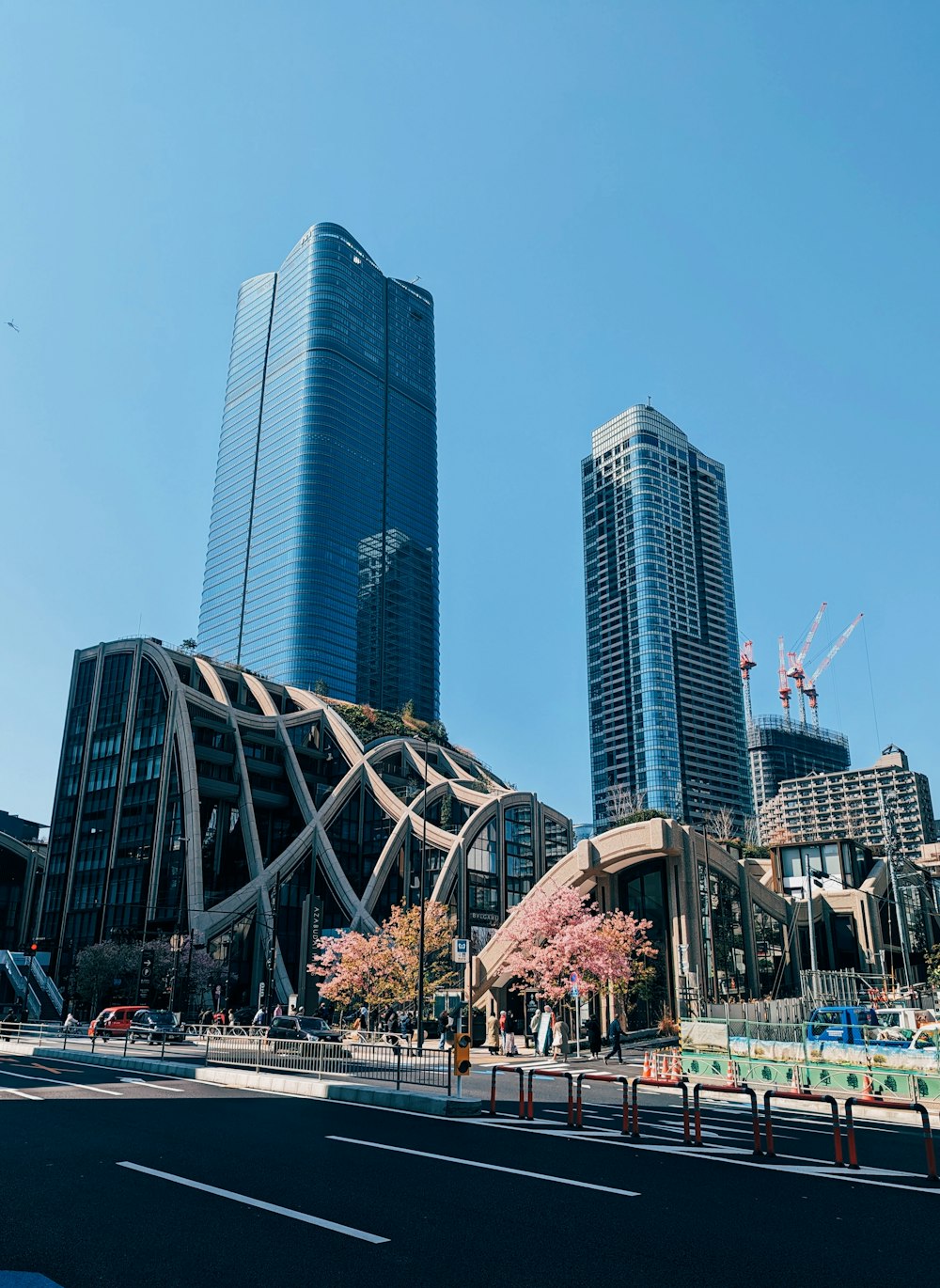 a city street with tall buildings in the background