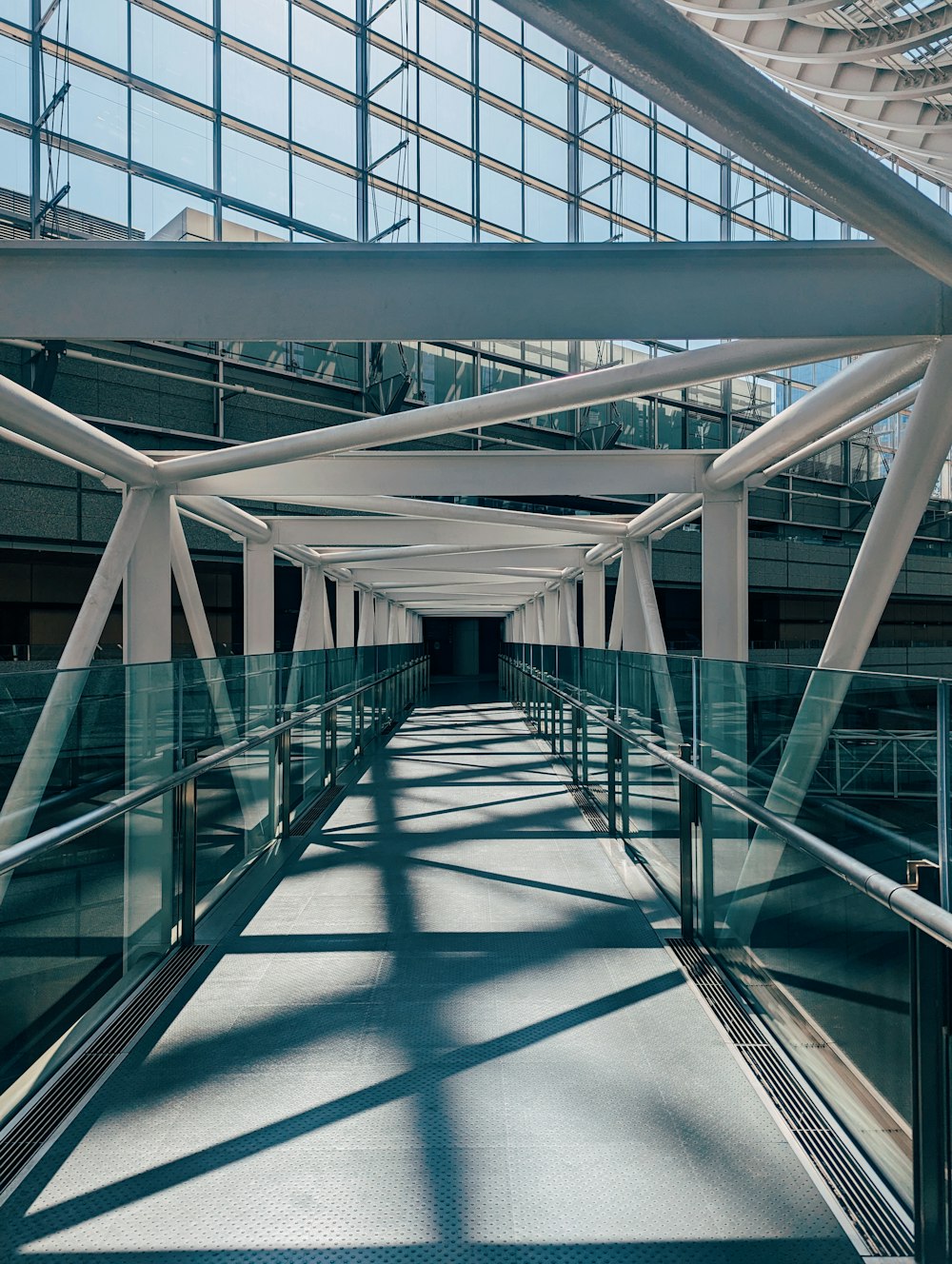 a long walkway with metal railings leading to a building