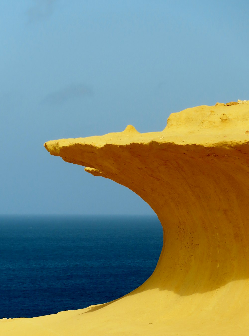 a person riding a surfboard on a wave shaped beach