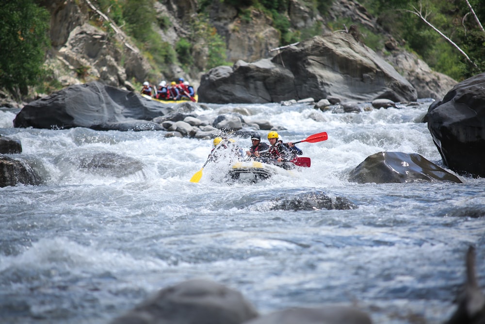 a group of people are rafting down a river