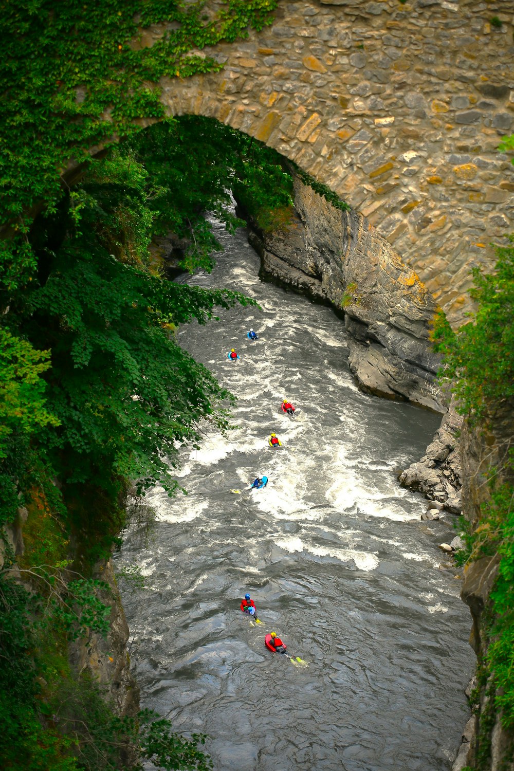 a group of people in rafts floating down a river