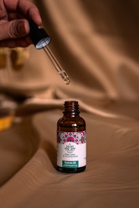 a person holding a small bottle of medicine