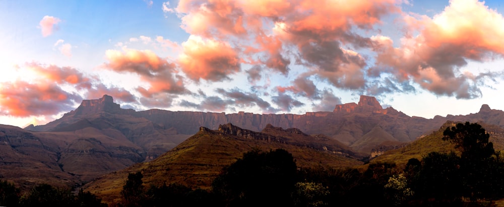 a view of a mountain range with clouds in the sky