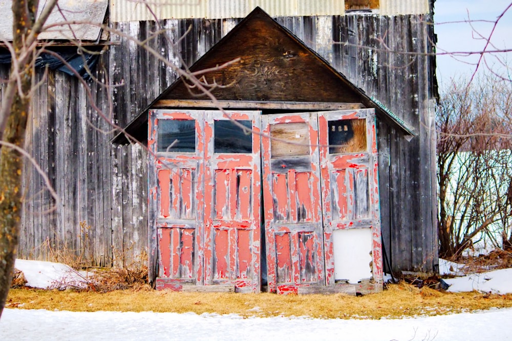 an old barn with a red door and window