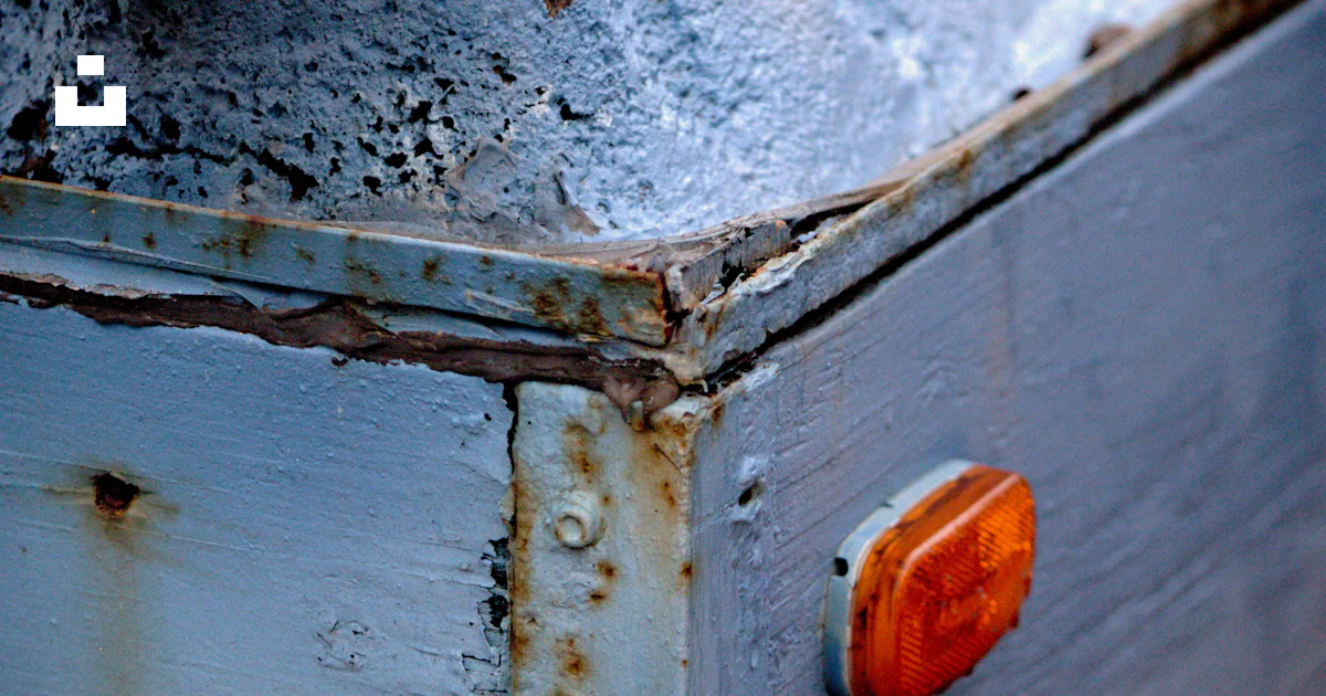 A rusted metal box with a red light on it photo – Free Industriel Image ...