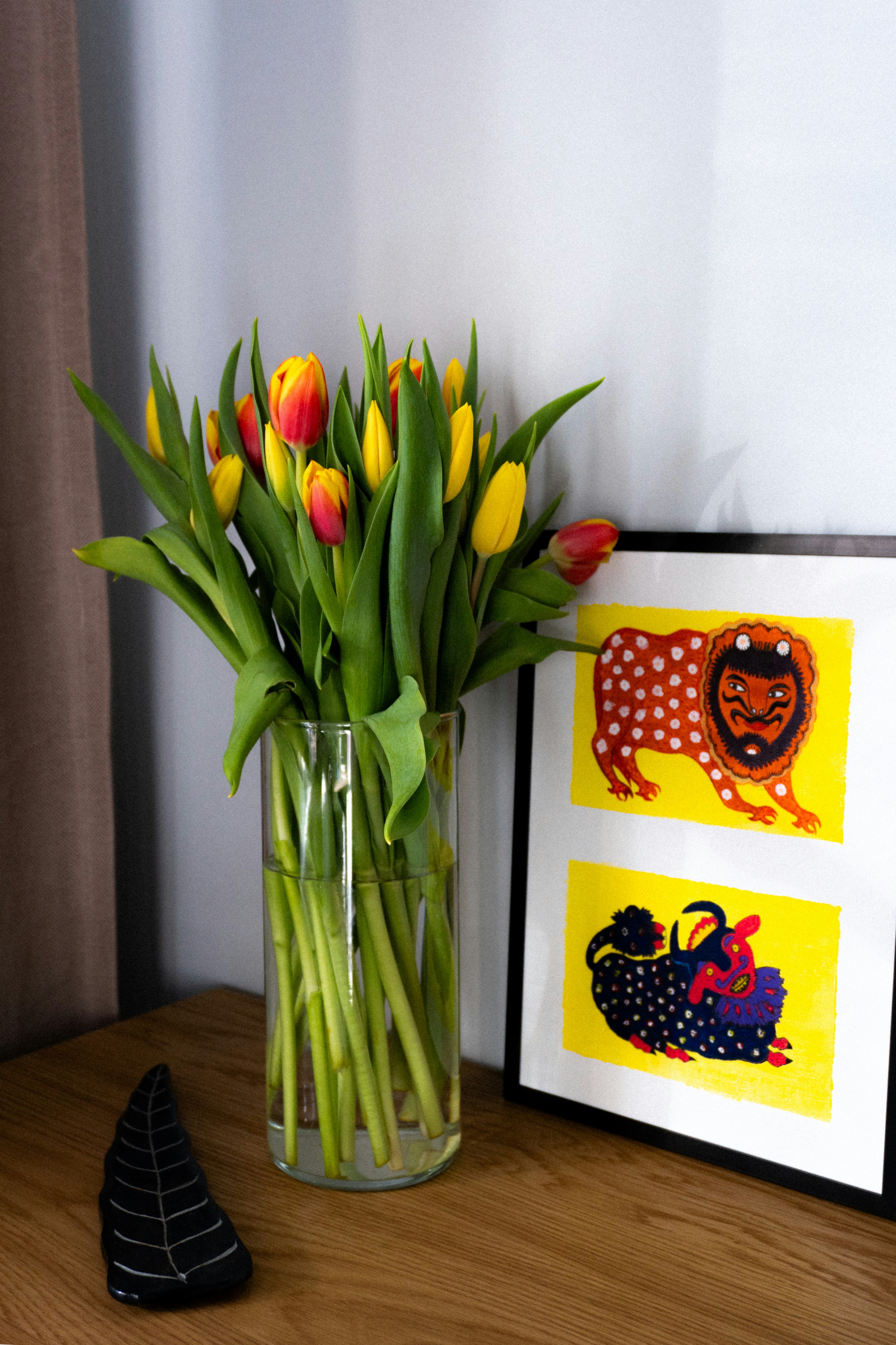 a vase filled with yellow and red tulips