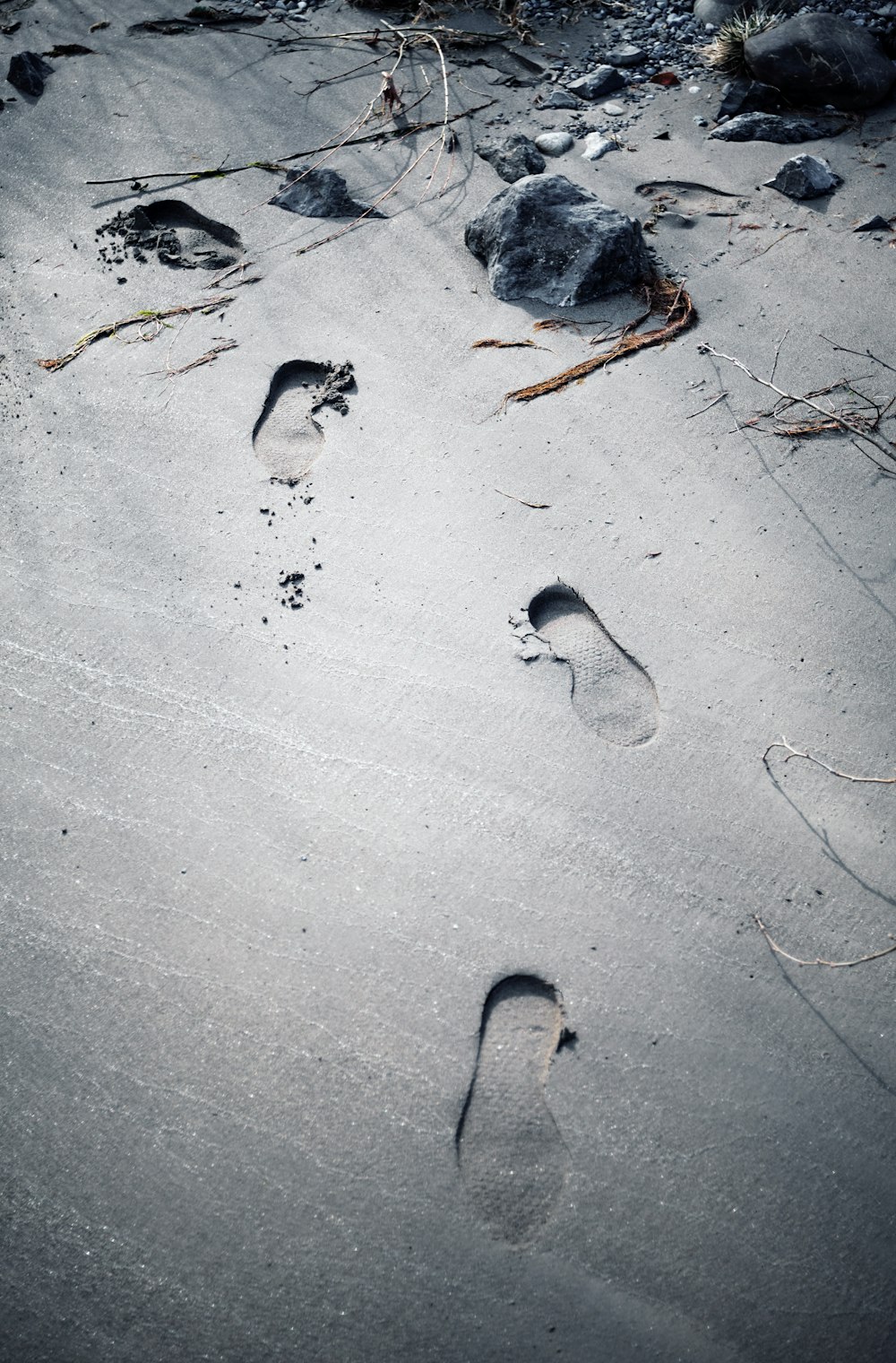 two footprints in the sand of a beach