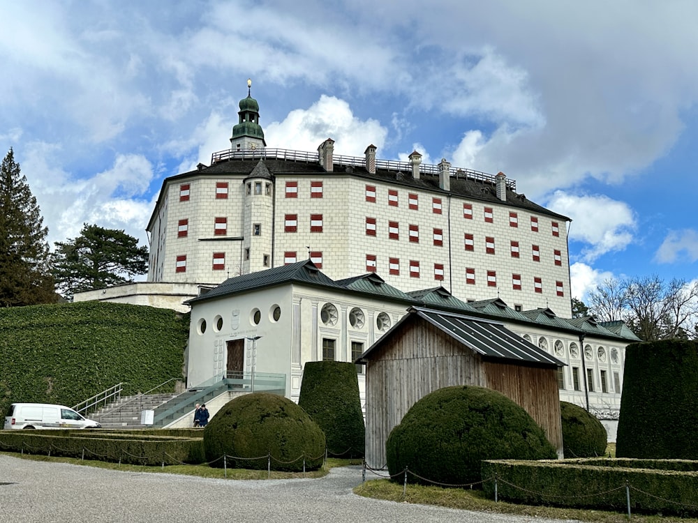 a large white building with a green roof