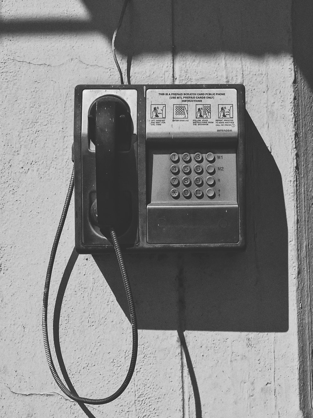 an old fashioned telephone on the side of a building