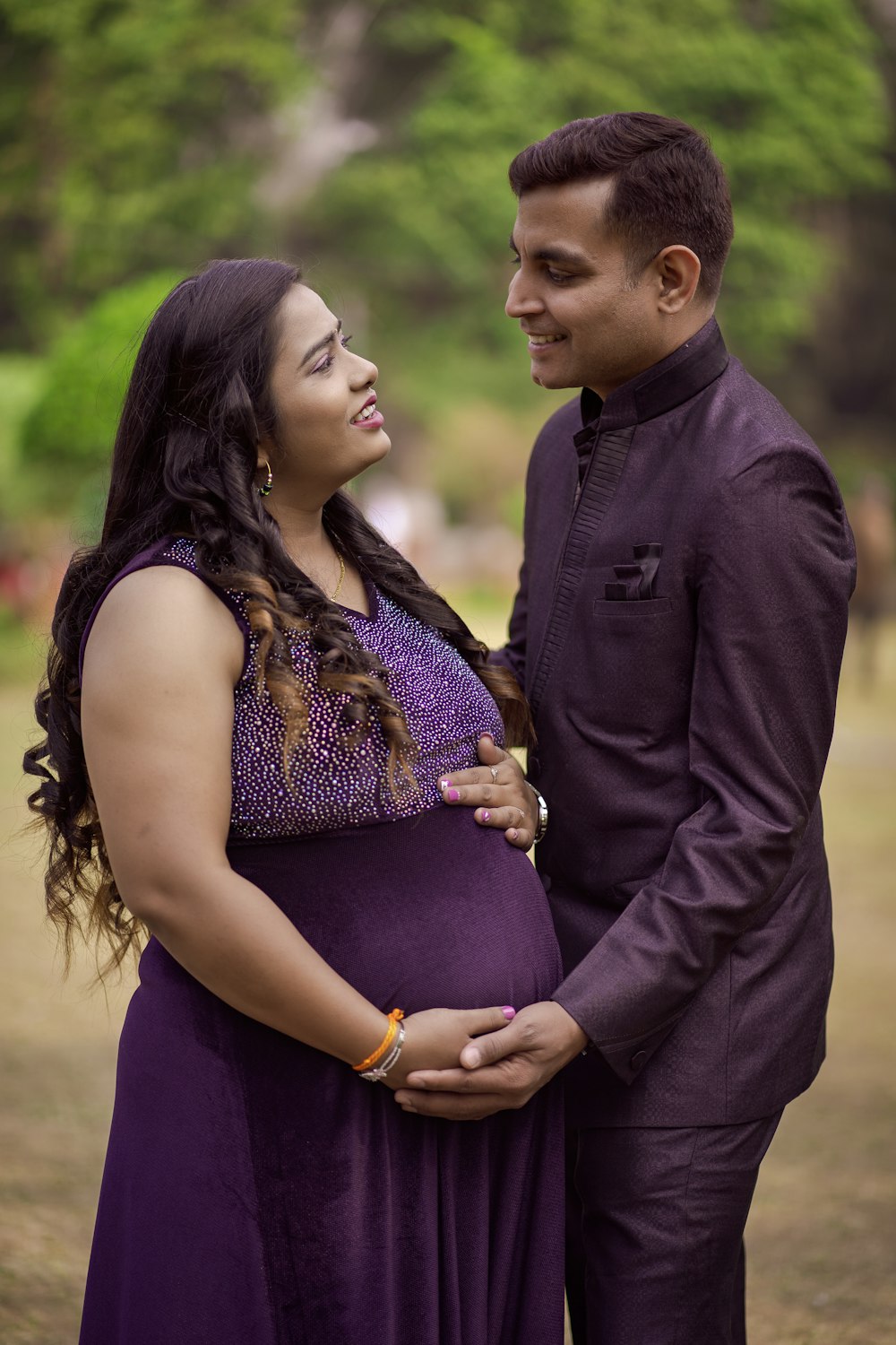 a pregnant couple standing next to each other