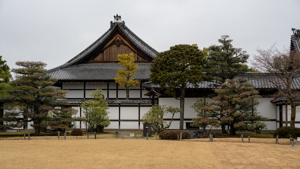 a white and black building with trees in front of it