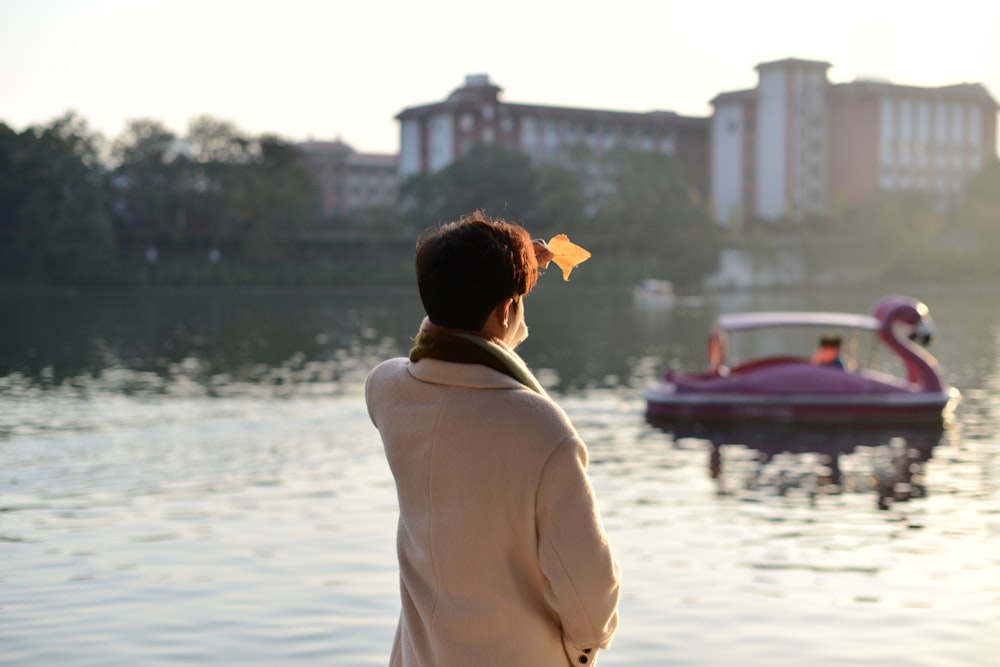 a woman looking at a boat in the water