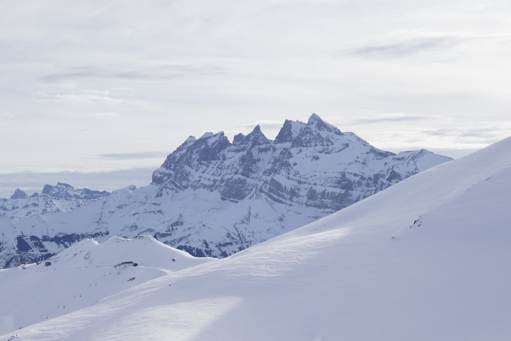 a man riding skis down the side of a snow covered slope