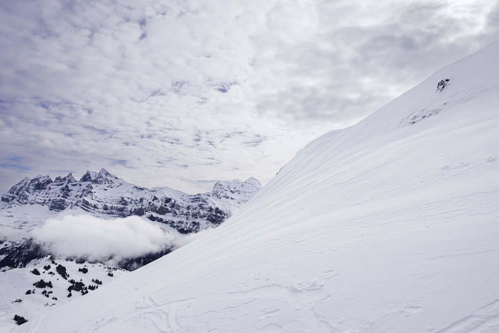 a man riding skis down the side of a snow covered slope