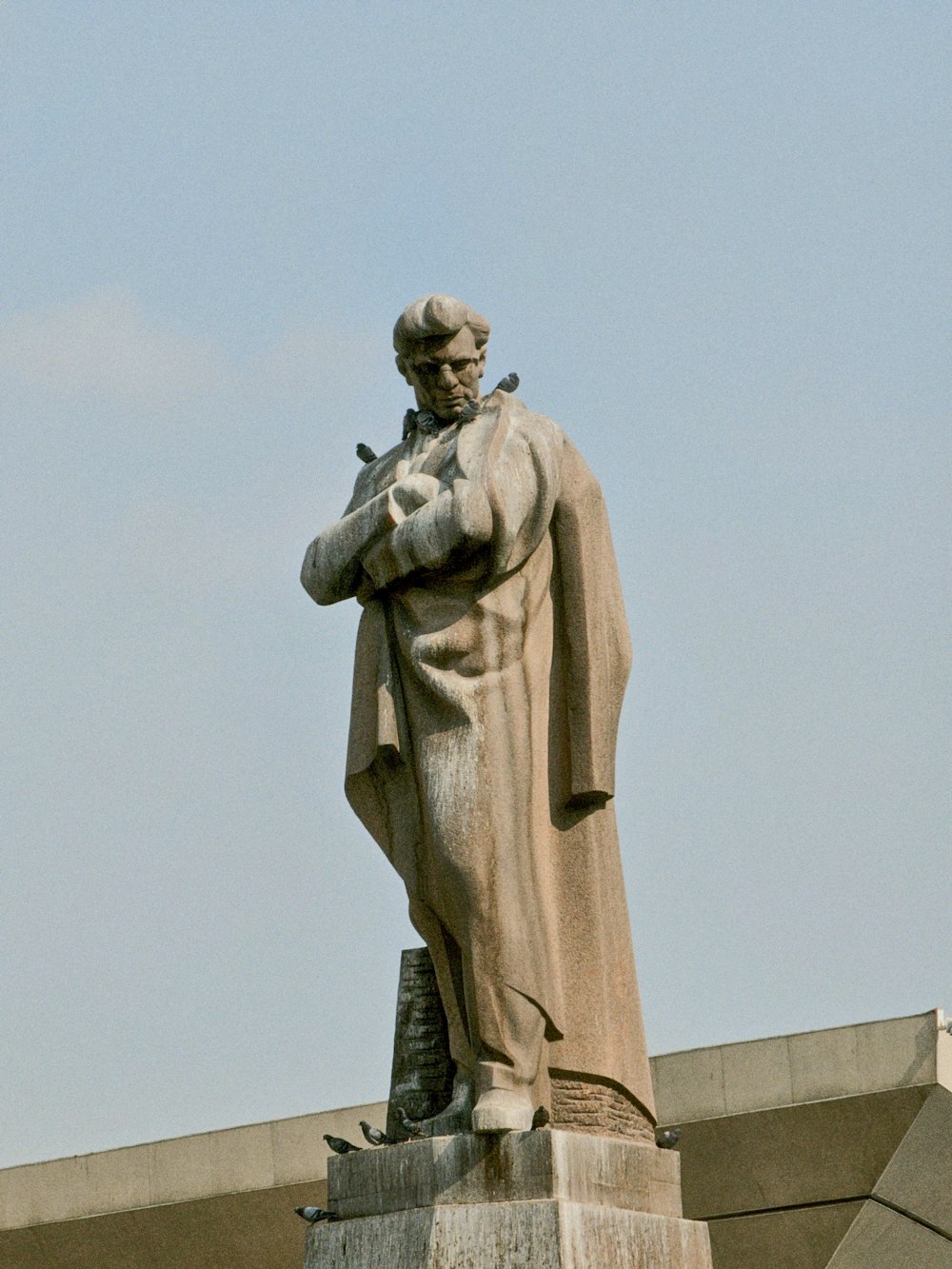 a statue of a man with a bird on his shoulder