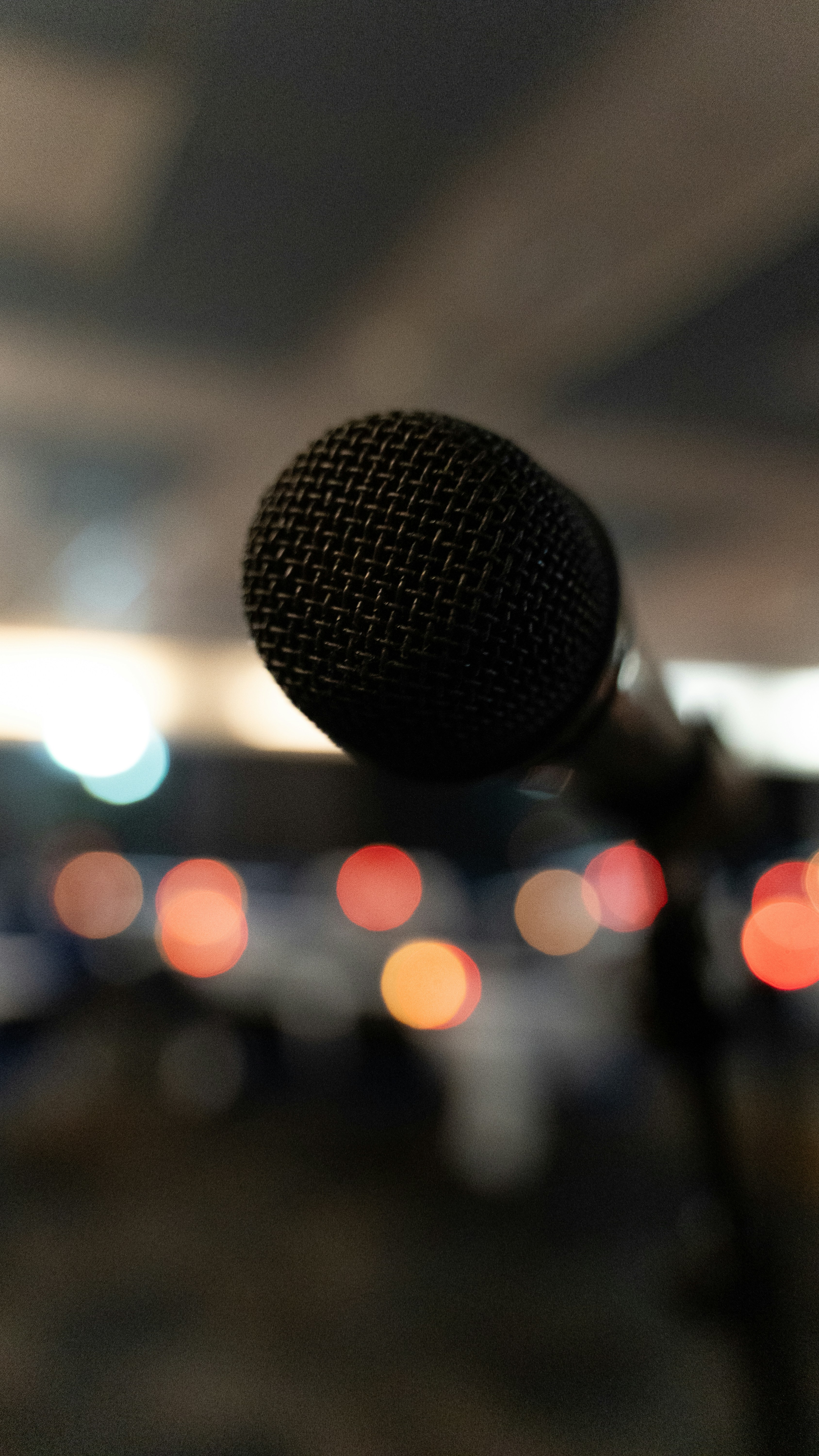 Microphone in foreground with blurred studio lights in background