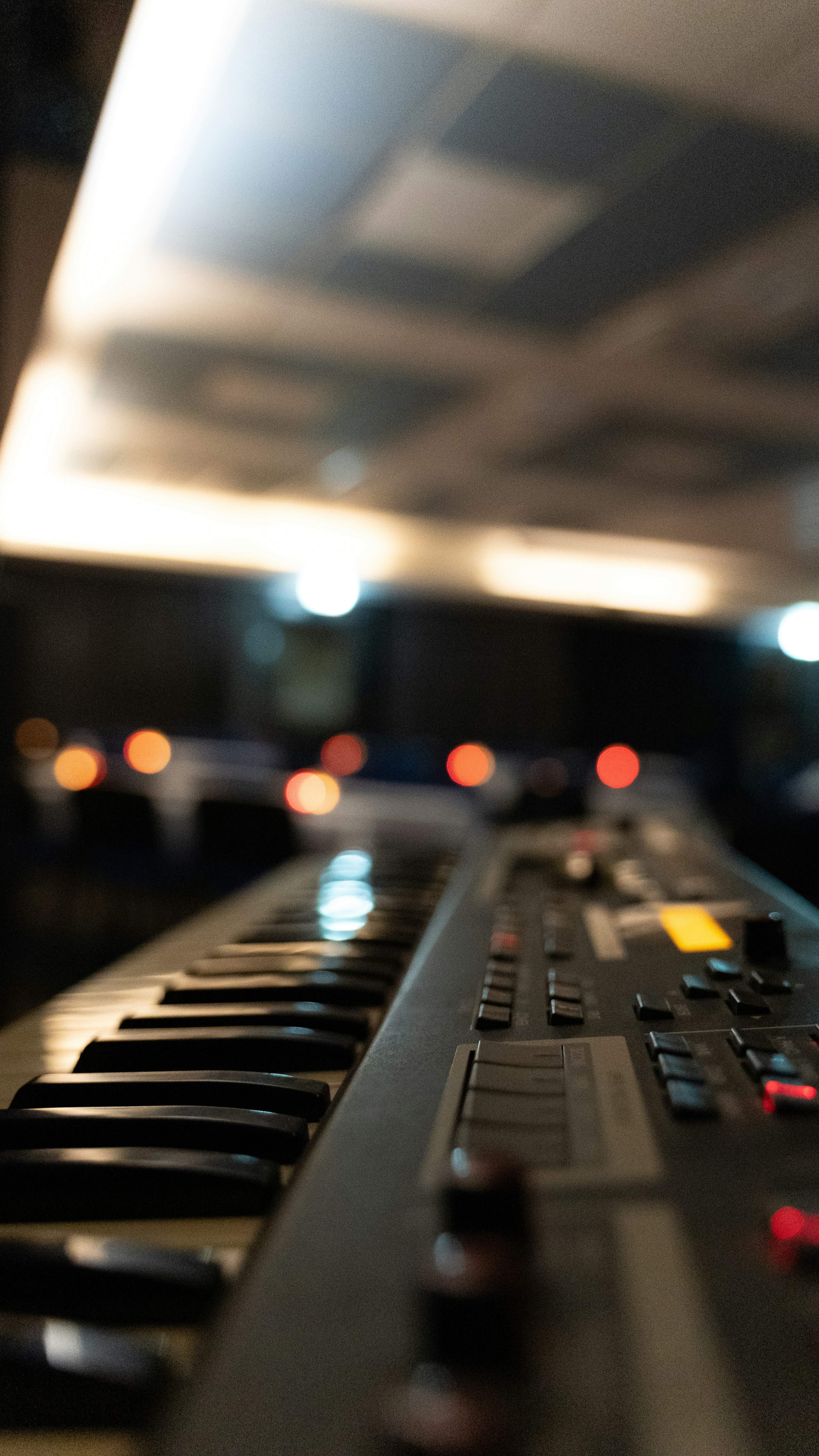 a close up of a keyboard with blurry lights in the background