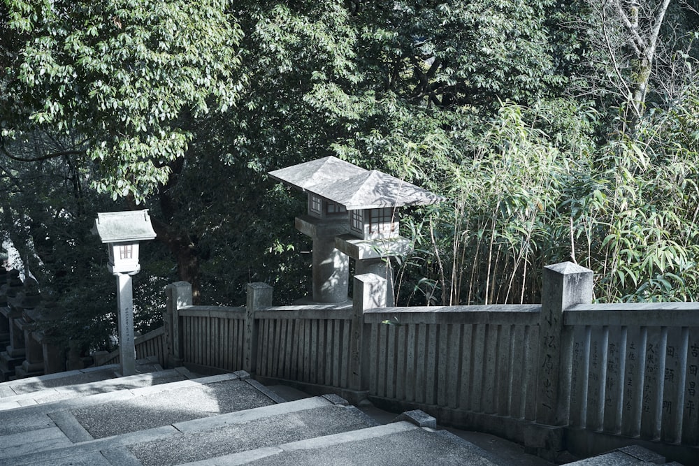 a wooden fence with a bird house on top of it