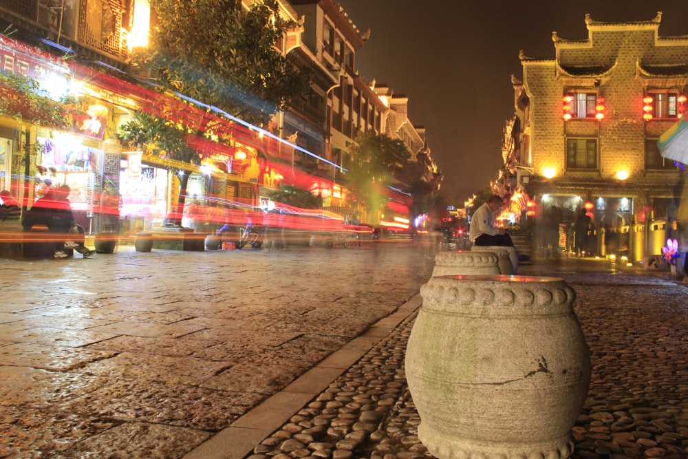 a city street at night with lights and buildings