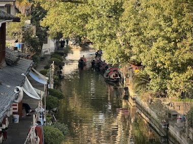 a narrow canal with a few boats on it