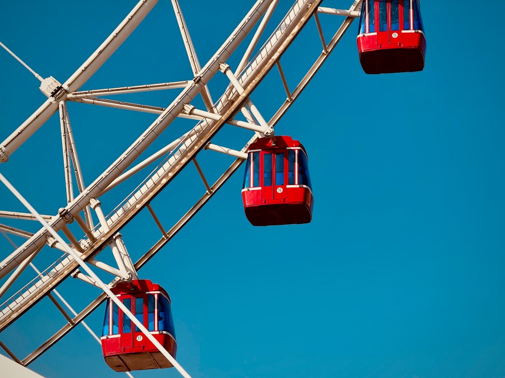 a ferris wheel with red seats on a clear day