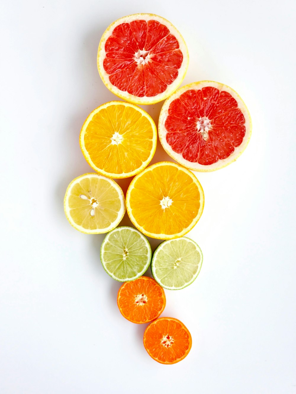 a group of oranges and limes cut in half